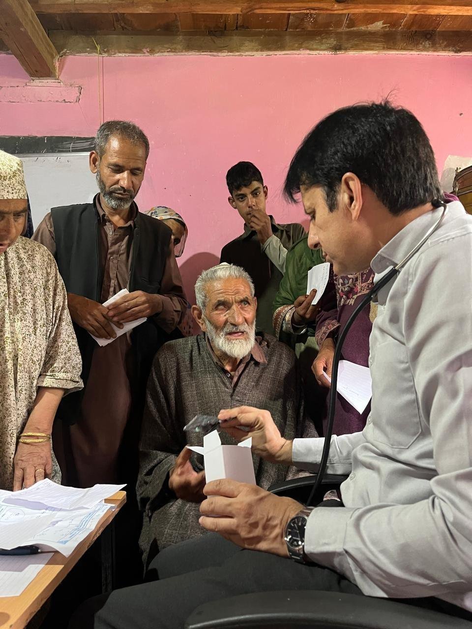 Dr. Ishfaq Chowdhary with an elderly patient