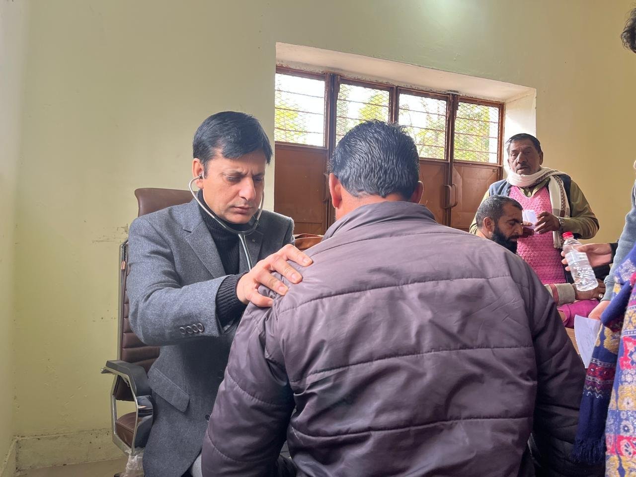 Dr. Ishfaq Chowdhary examining a patient